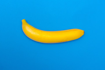 Ripe banana on blue background. The concept of healthy eating. The concept of summer.