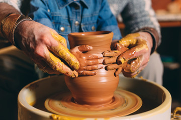 Pottery workshop. Grandpa teaches granddaughter pottery. Clay modeling