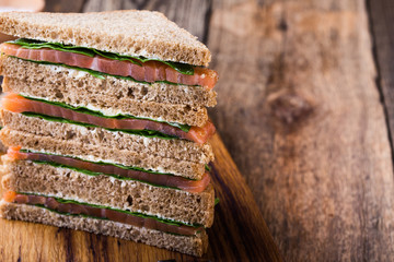 Healthy vegetarian sandwiches with smoked salmon and greens