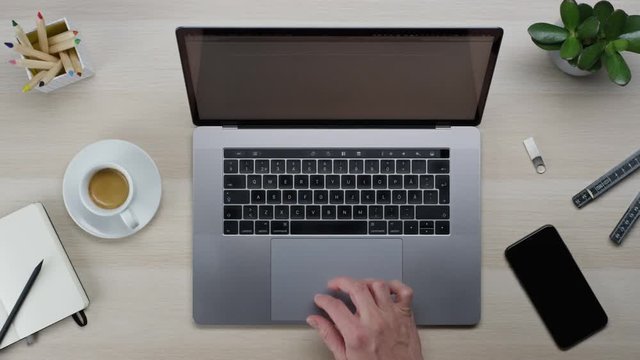 Male hands typing laptop on white clean minimalistic table with top view, gestures and finger movements