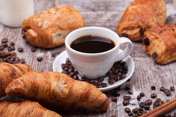 Cup of Coffee with Pastry on rustic wood table background