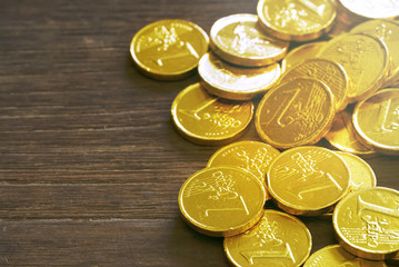 Gold coin on wood table