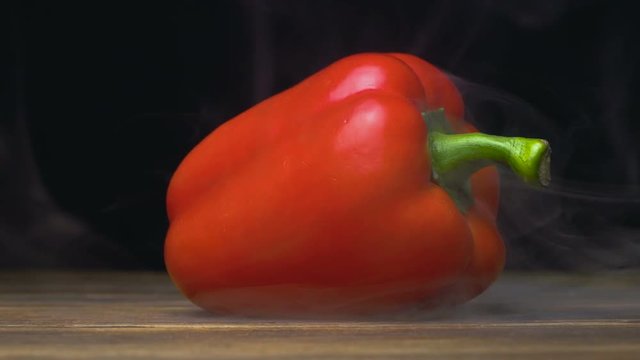 capsicum or sweet red bell pepper in cold, steam from frost in slow motion, cloese up