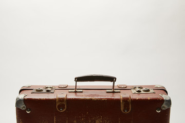 brown suitcase on grey background with copy space