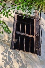 An old convicts jail in Bangkok, Thailand. At present, this prison is the public park named "Suan Rommaneenat" park. Old opened window of prison building.