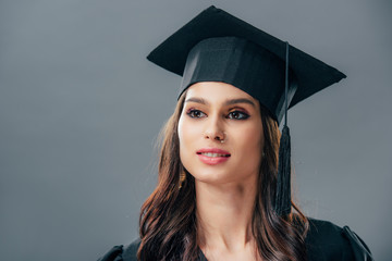 elegant female indian student in graduation hat, isolated on grey