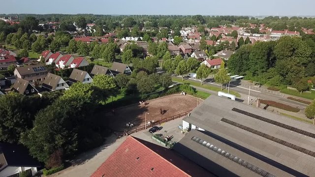 Drone view kids riding horses in Dronten, Flevoland, The Netherlands.