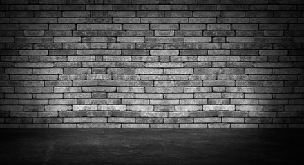 background of an empty black room, a cellar, lit by a searchlight. Brick black wall and wooden floor