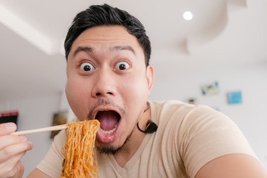 Close Up Portrait Of Happy Asian Man Eat Noodle.