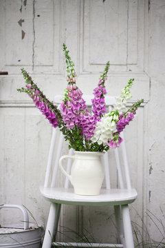 beautiful bouquet of field flowers - foxglove against the background of old white door