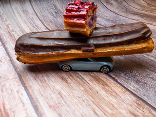 Eclair with chocolate fudge on a car, eclair delivery concept