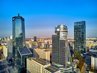 WARSAW, POLAND - FEBRUARY 10, 2019: Beautiful panoramic aerial drone view to panorama of Warsaw modern City, Q22 - neomodern office skyscraper designed by APA Kuryłowicz & Associates - obrazy, fototapety, plakaty