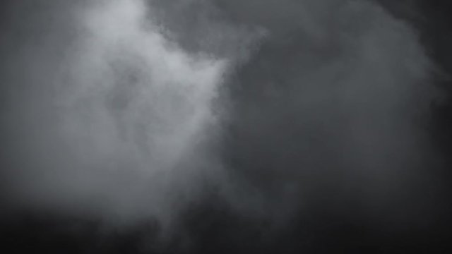 Atmospheric smoke VF overlay element. Haze background. Smoke in slow motion on black background. White smoke slowly floating through space against black background. Mist effect. Fog effect.