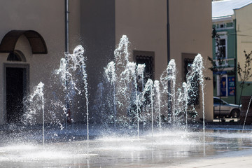 A fountain flowing through the pavement