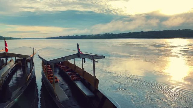 Pirogues docked at Madre De Dios river inside the Amazon rainforest of Peru at Puerto Maldonado.