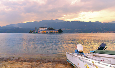Panoramic view of island of San Giulio on the Italian Orta lake with mountains in background - lago d'Orta, Piemonte, Italy.