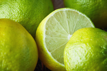 Fresh ripe organic limes on rustic wooden background