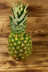 Whole pineapple on wooden table