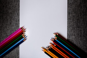 colored pencils with a white sheet