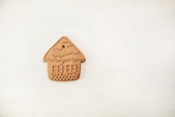  gingerbread house on white wooden background