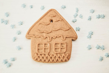  gingerbread house on white wooden background