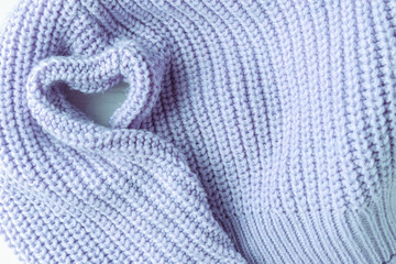 knitted jacket blue on white brick background