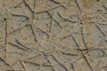 Beautiful background with flowers carving on the old stone.