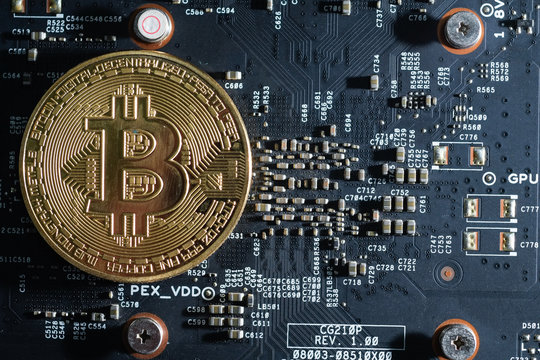 Royalty high quality free stock photo of close up Gold bitcoin electronic coin icon is on an electronic circuit board. Cryptocurrency golden bitcoin coin