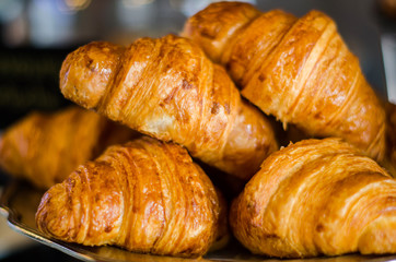 Croissant is a type of bread that is put together on an iron tray.