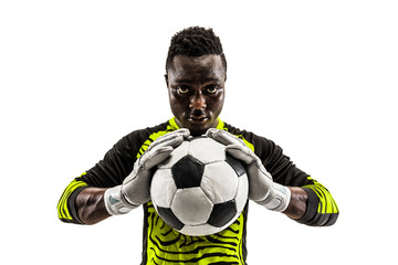 One african male soccer player goalkeeper standing and holding ball. Silhouette isolated on white studio background