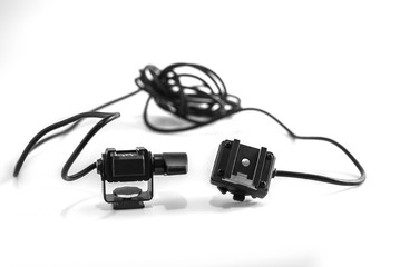 Closeup detail of a professional flash cord connector for photographer with a didital dslr camera, isolated on white background