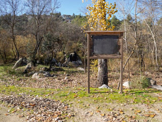 mockup of a wooden sign with blackboard in the field
