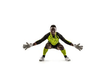 Goalkeeper ready to save on white studio background. Soccer football concept