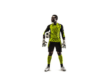 One african male soccer player goalkeeper standing and holding ball. Silhouette isolated on white studio background