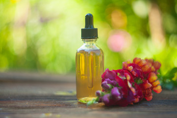 antirrhinum essential oil in  beautiful bottle on table