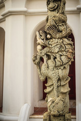 Chinese dragon pillar stone carving column outside in Thai temple. Traditional stone dragon column decoration in the Buddhist temple, Bangkok, Thailand.