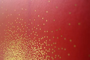 gold dots on red background
