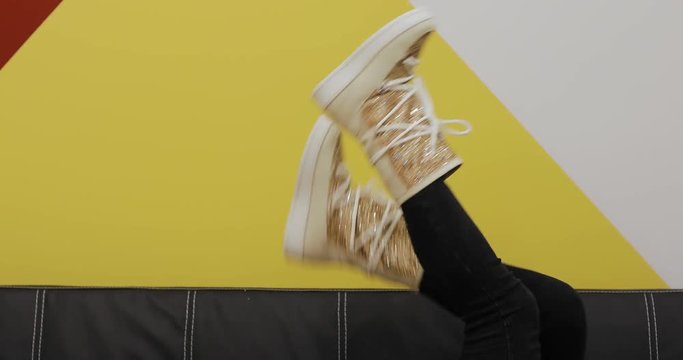 Ugg boots on women legs at color wall background, creative video