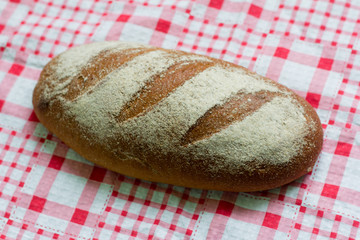 fresh grey bread on a checkered napkin