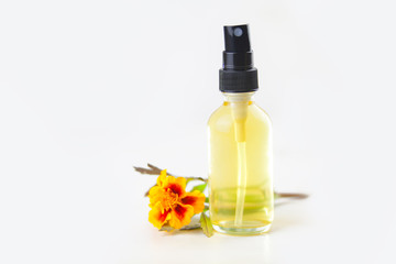 marigold essential oil in  beautiful bottle on White background