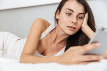 Obraz premium Beautiful young woman relaxing on bed at home