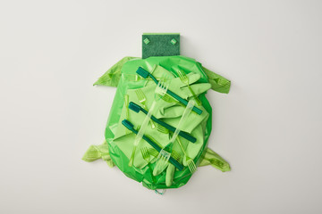 top view of turtle figure made from disposable plastic tableware, bag, sponges and rubber gloves...