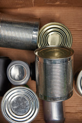 different iron silver cans in cardboard box