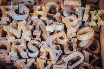 Wooden letters of the English alphabet for sale in the wood shop. Alphabet made of wooden letters for learning and education concept.