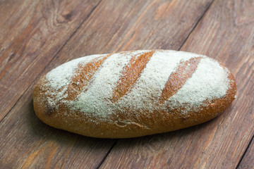 fresh grey bread on wooden background