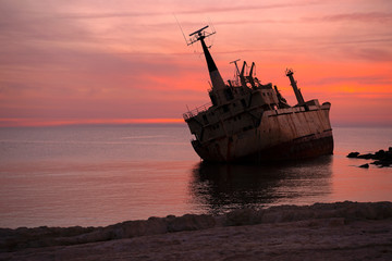 Fototapeta premium Beautiful seascape and shipwreck. Abandoned ship Edro III at sunset near the Paphos, Cyprus.