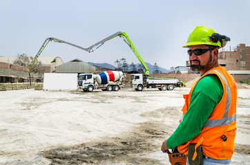 Concrete pump operator with remote control for boom pump truck at construction site. © Peruphotoart