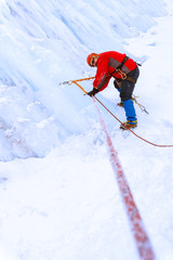 Fototapeta na wymiar climber moves traverse the ice wall