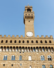 Fototapeta premium Color DSLR image of the historic landmark Tower of the Palazzo Vecchio, Florence, Italy, against a blue sky. Vertical with copy space for text