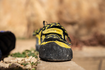 Closeup of cat foot boot in black and yellow colors for climbing in mountains